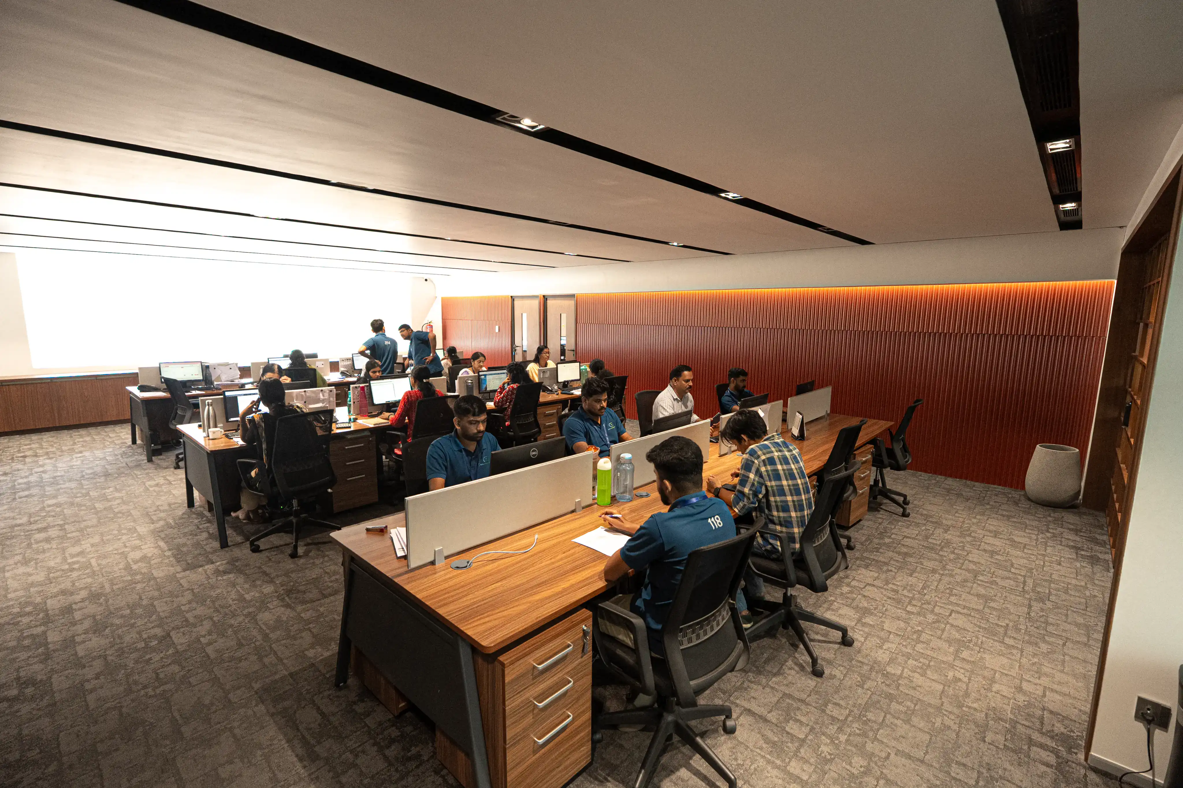 Open office workspace with multiple employees at desks