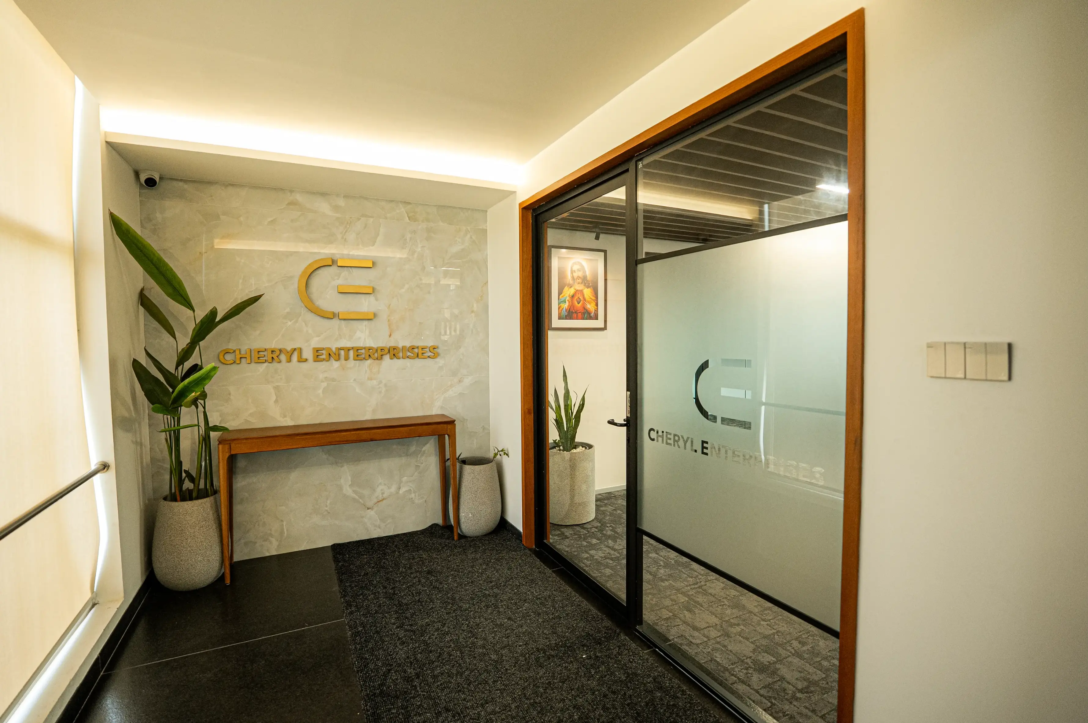 Office lobby with Cheryl Enterprises signage and glass door