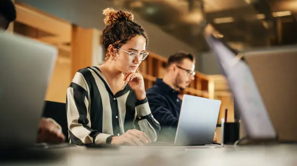 Professional woman working on laptop in office